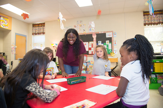 MSU elementary education major Taylor B. Skinner of Cormorant facilitates Math Day games with Sudduth Elementary first graders as part of the education partnership between MSU and the Starkville Oktibbeha School District. (Photo by Megan Bean)
