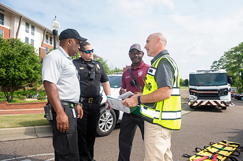 Responding to a hypothetical emergency scenario during the MSU preparedness exercise held May 19 are, from left, OCH Regional Medical Center EMS Supervisor Shedrick Hogan; MSU Police Sergeant Nick Coe; Starkville Fire Department Battalion Chief Roosevelt Harris; and MSU Crisis Action Team Representative and On-Scene Controller Brian Locke. 