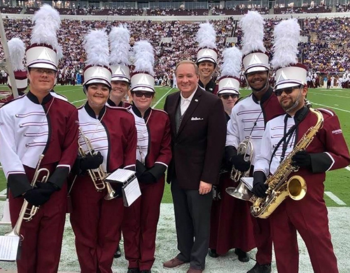 Famous Maroon Band members and MSU President Mark E. Keenum on the sidelines during the MSU vs. LSU game at Davis Wade Stadium.