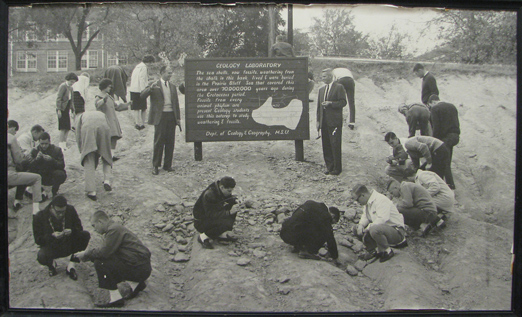 In the last century, the “Geology Laboratory” included the exposed Cretaceous chalk outcrop behind Harned Hall. This 1960s-era photo shows geology faculty and students as they investigate and collect 70 million-year-old marine fossils from the campus outcrop. 
