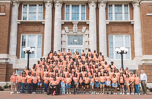 Global Teaching Project Advanced STEM Summer Preparatory Program leaders and participants pose outside of Lee Hall. 