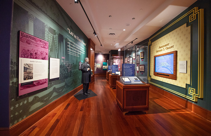 A view of the Grant Presidential Library with wood flooring, display cases and a Grant statue.