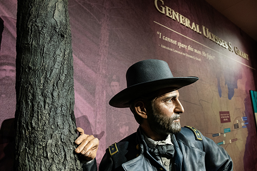 Statue of Ulysses S. Grant standing next to a tree statue at MSU's Grant Presidential Library