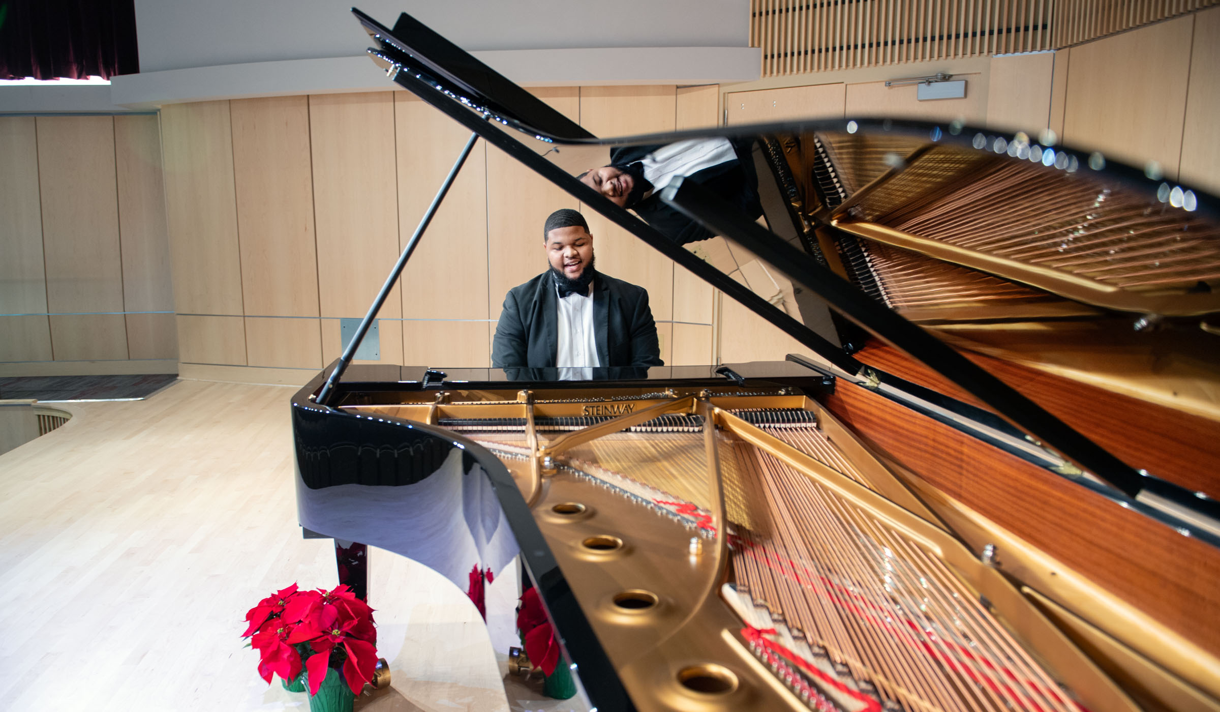 Desmond Henderson, pictured playing a Steinway piano in MSU's new Music Building