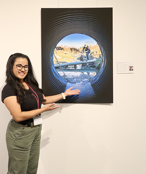 Lorena Chavarro-Chaux, pictured next to her image on display in an art gallery