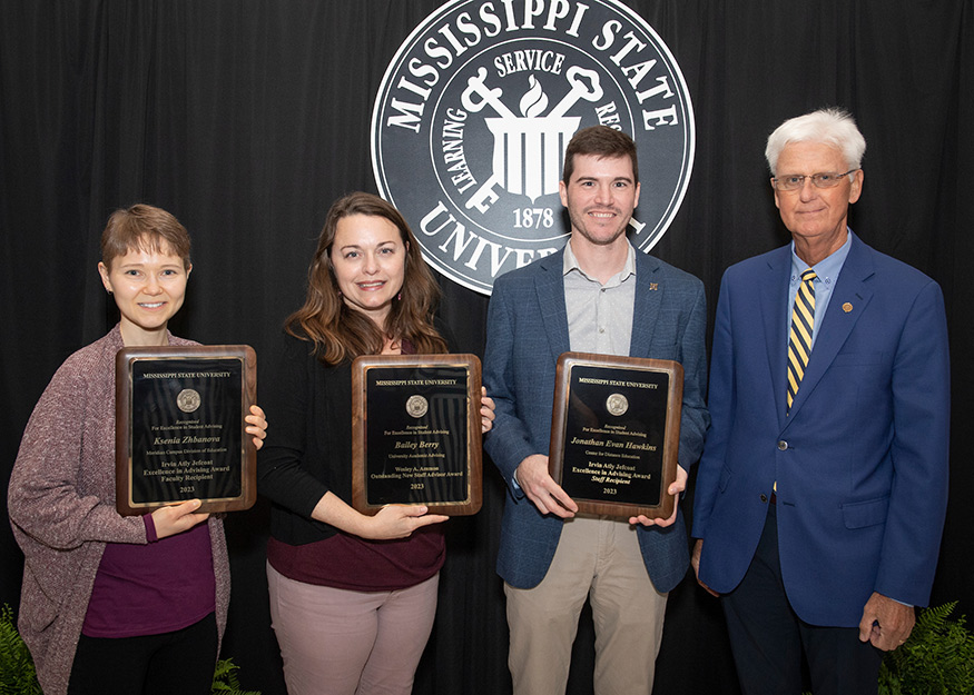 Advising award recipients (l-r) Ksenia Zhbanova, Lynda Moore accepting on behalf of Bailey Berry, and Jonathan Evan Hawkins, are pictured with Executive Vice Provost Peter Ryan.