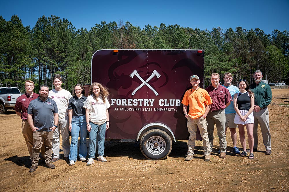 MFC donation to Forestry Club with students and staff