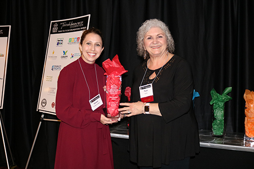 Pam Dollar presents to Torchbearer Award to Kassee Stratton-Gadke