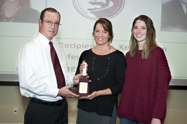 Lewis Brown Jr. and MSU American Society for Microbiology Student Chapter President Cati Cowick present the Dr. Lewis Brown Lectureship Award to San Diego State University Professor of Microbiology and Immunology Kelly Doran. (Photo by Russ Houston)