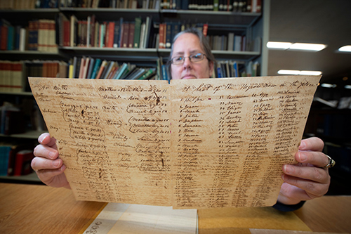 MSU Libraries Coordinator of Manuscripts and Associate Professor Jennifer McGillan reviews historic documents that are part of the Lantern Project