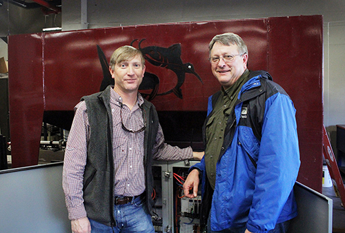 Wes Lowe, left, research associate III in MSU’s Department of Agricultural and Biological Engineering, is pictured with MAFES Research Professor David Wise. Wise led the MSU team developing the oral vaccination platform. Lowe and Daniel Chesser, not pictured, designed the delivery system, which was instrumental in commercializing both technologies. (Photo by Kenner Patton)