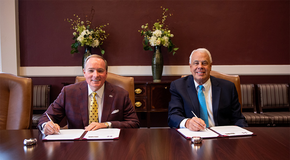 MSU President Mark E. Keenum, left, and Moore Tech President Skip Redmond sign a memorandum of understanding 
