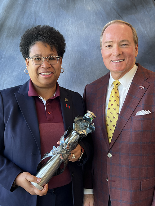 Tonya McCall and Mark Keenum pictured with a trophy for the 2023 Instant Impact Award