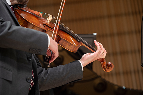 A close up of Daniel Stevens playing the viola