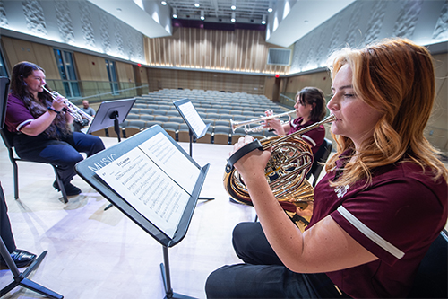 Students practice for a brass performance