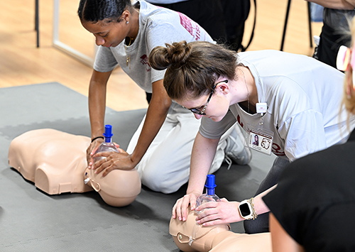 Jada Bantom of Byhalia, left, and Taylor Adcock of Richton practice basic life support methods during a foundational course offered to Mississippi State-Meridian’s inaugural Accelerated Master of Science in Nursing cohort.