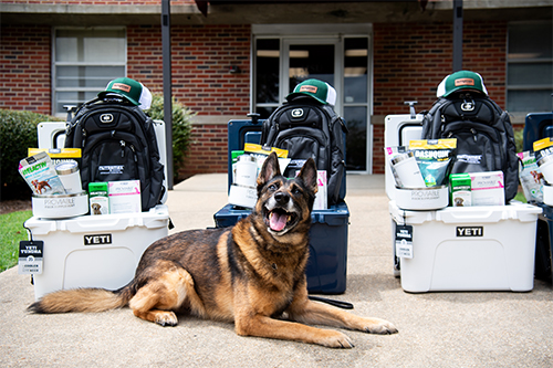 MSU PD K-9 Miguel poses with donated supplements and swag courtesy of Nutramax.