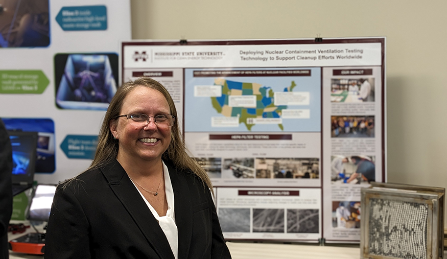 Jaime Rikert, pictured in front of an informational display