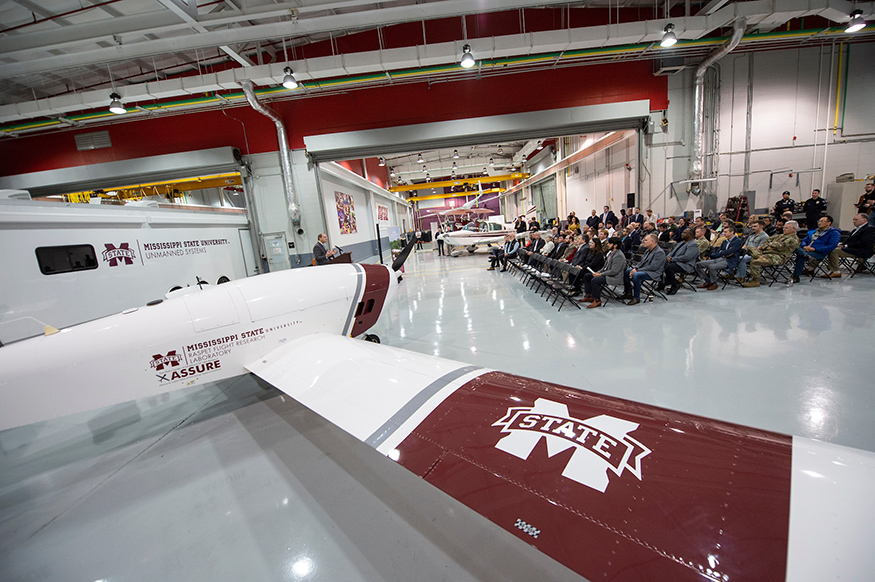 With the Teros UAS in the foreground, MSU President Mark E. Keenum speaks from the podium.