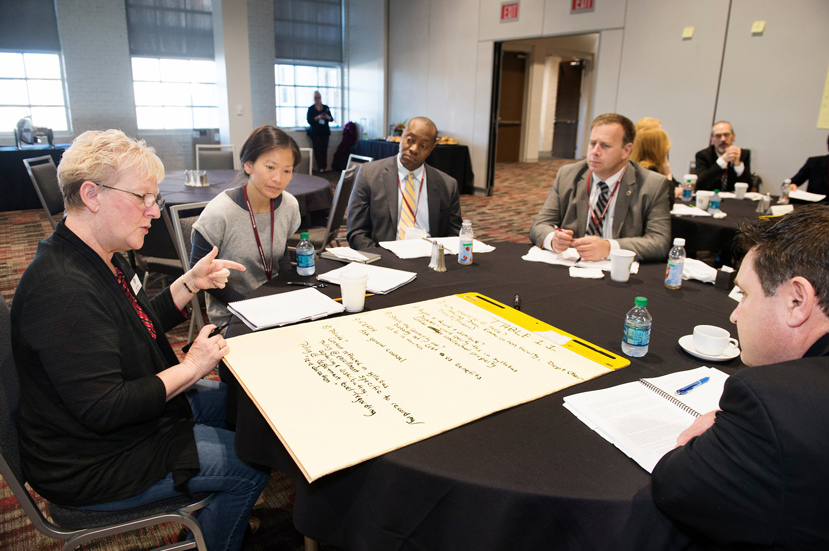 SEC Academic Leadership Development Program (SEC ALDP) Fellows participate in an "in basket exercise" at The Mill at MSU Conference Center. The team of participants working together includes, from left to right, Alice March of the University of Alabama, Susan Kuo of the University of South Carolina, Marshall Shepard of the University of Georgia, Scott Willard of Mississippi State University, and Tony Ammeter of the University of Mississippi. (Photo by Megan Bean)