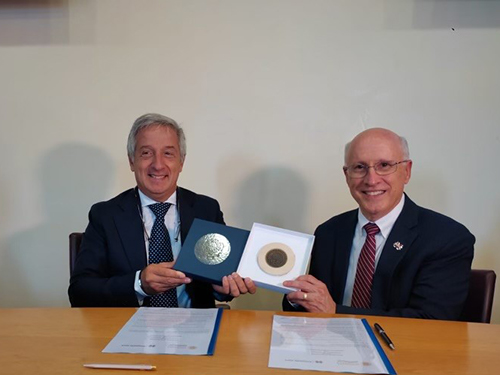 David Shaw and Fabio Pollice hold up mementos from the signing of a memorandum of understanding.