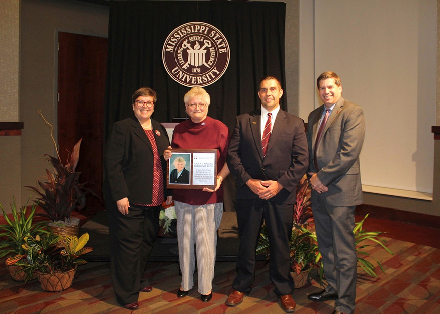 Marking the 20th anniversary of MSU’s Joe Frank Sanderson Center, home of University Recreation, are (l-r) Vice President for Student Affairs Regina Young Hyatt; retired Director of University Recreation Laura E. Walling, who was recognized for her service by having the Sanderson Center’s conference room named in her honor; Sanderson Center Associate Director for Programming and Operations Jason Townsend; and Assistant Vice President for Student Affairs Jeremy Baham. (Photo by Emily Pomykalski) 