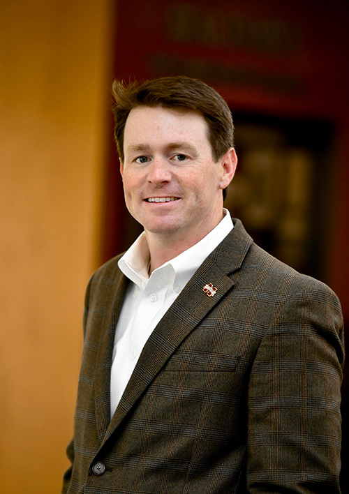 Portrait of Will Staggers wearing a sport coat and MSU lapel pin