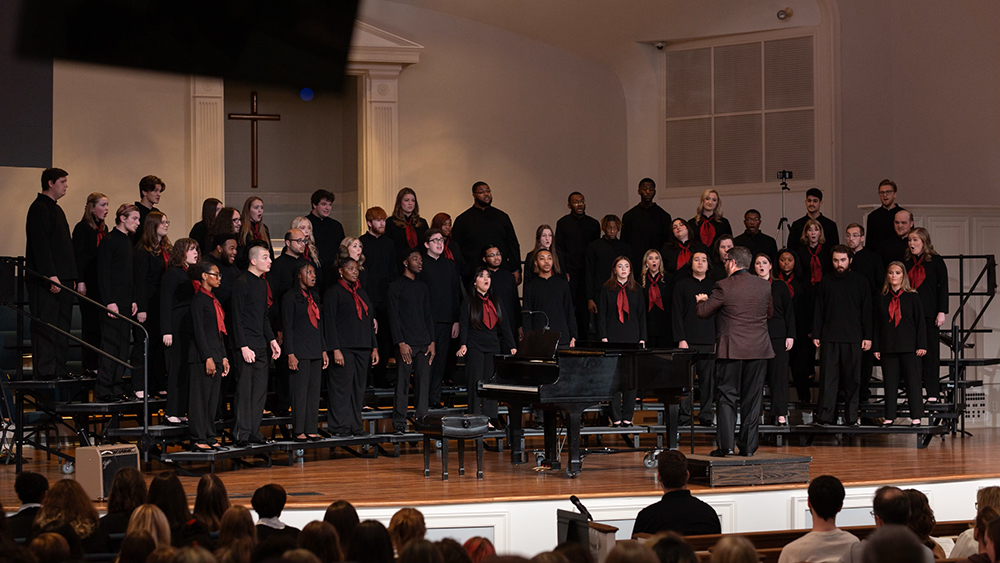Choir members sing in a large church