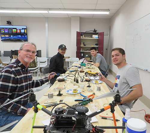 Pictured from left, Louis Wasson, senior Extension associate with MSU’s Geosystems Research Institute; Nitant Rai, a forestry master’s student from Nepal; Hunter Blalock, an agriculture master’s student from Madison; and Antonio Correa Tavares, a plant and soil sciences doctoral student from Brazil, build drones in an ag flight technologies course this semester. 