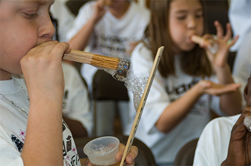 Children participate in activities during the Wood Magic Science Fair.