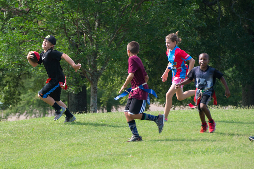 Participants at MSU’s “Youth Dawgs” summer camp play flag football during a week of activities. The camp is among the healthy campus initiatives receiving support from a grant from the Blue Cross & Blue Shield of Mississippi Foundation. (Photo by Russ Houston)
