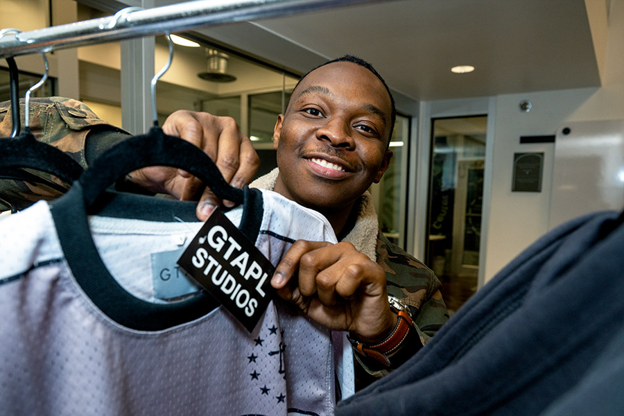 young man holding a shirt