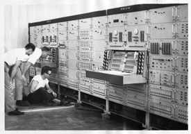 Early black and white photo of MSU students in a computer lab.