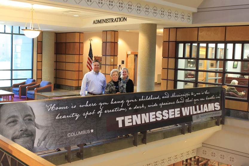 Left to right, Associate Dean of Libraries Stephen Cunetto, Dean of Libraries Frances Coleman, and Coordinator of Cultural Heritage Projects Sarah McCullough are pictured with a new banner commemorating Tennessee Williams. Each month during the academic year the library will unveil a banner featuring one of the Mississippi writers on the Southern Literary Trail.  (Photo by Isa Stratton, MSU Libraries)