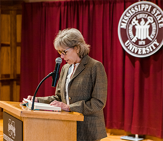 Mayor Lynn Spruill reads at a podium