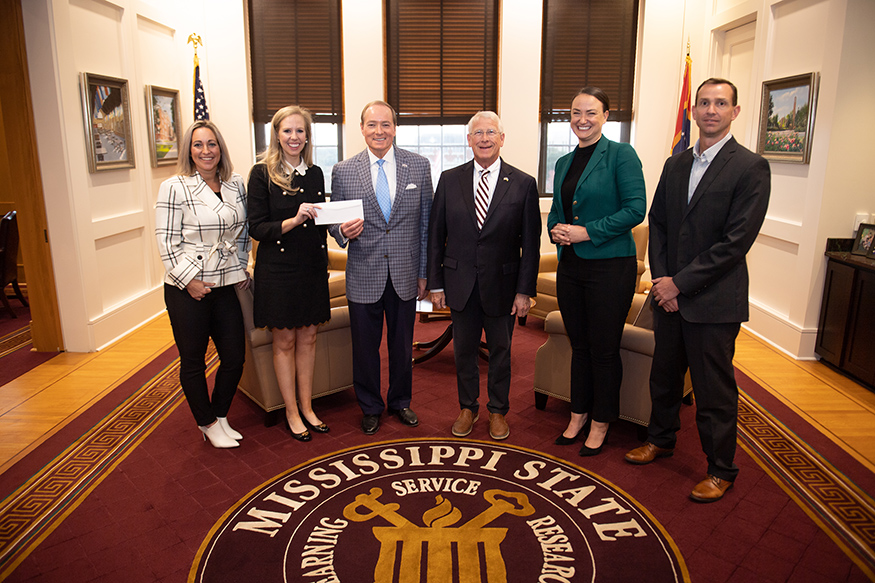 Boeing representatives present a check to MSU President Mark E. Keenum