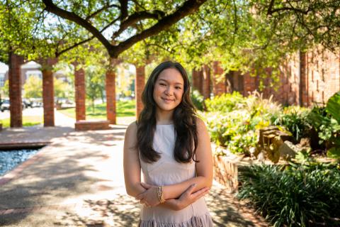 Photo of Isabella standing near the chapel of memories