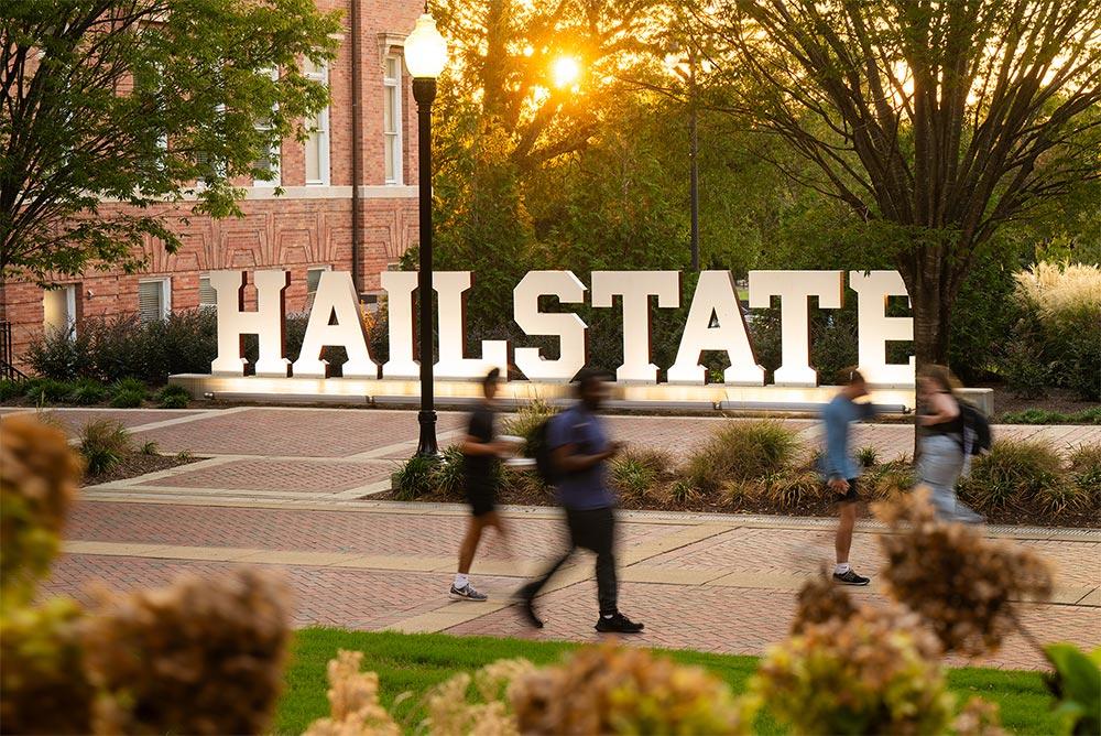MSU's Hail State sign near McCool and Montgomery halls is pictured as students walk by.