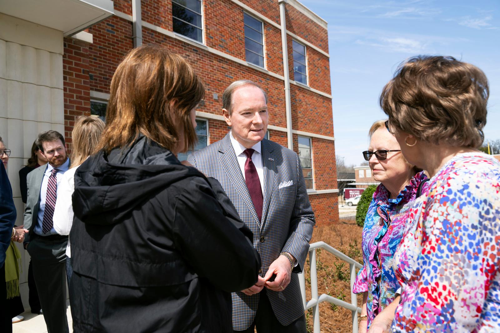 MSU President Mark E. Keenum visits with members of the Ballew family, who were special guests at the grand opening of the newly renovated Ballew Hall.