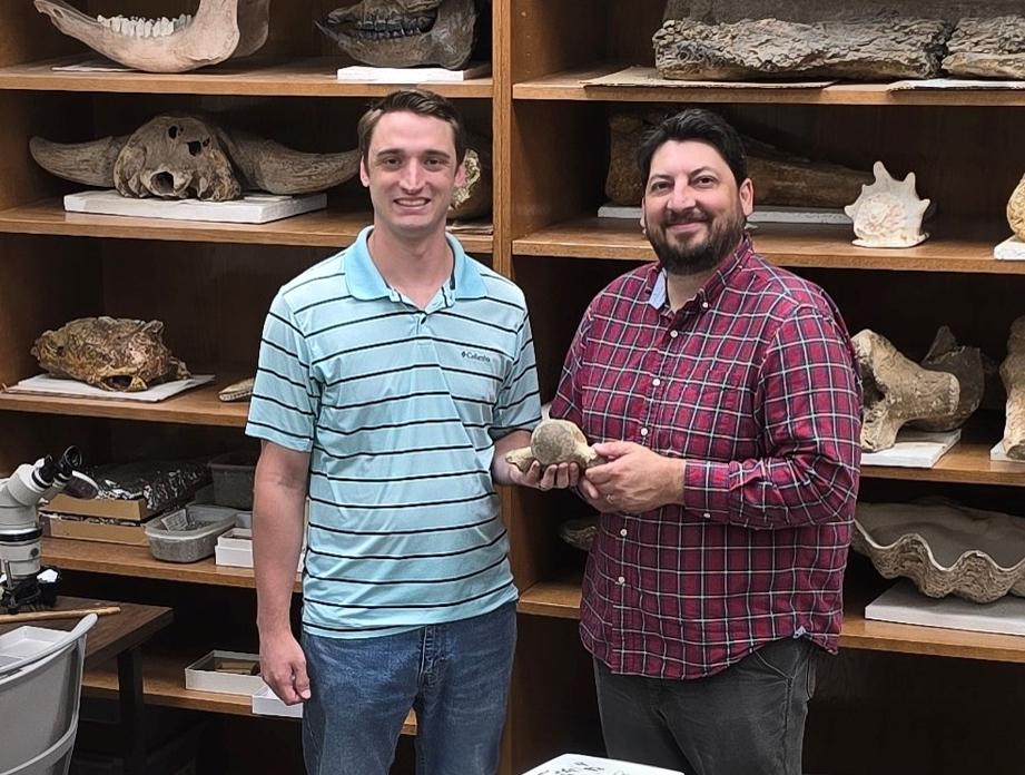 Leard (left) and Palmer with the mosasaur fossil found recently near Starkville