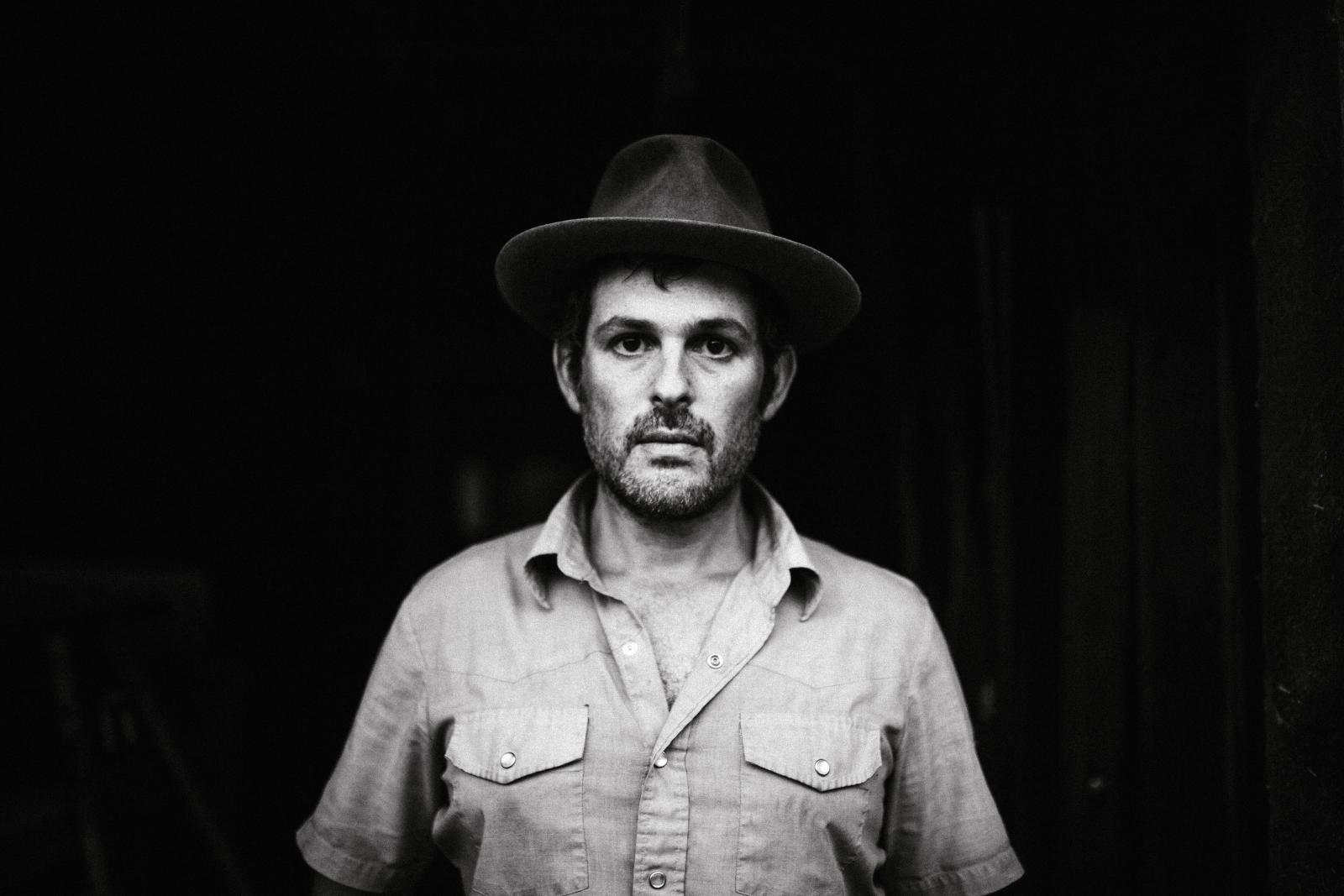 black and white photo of man in hat