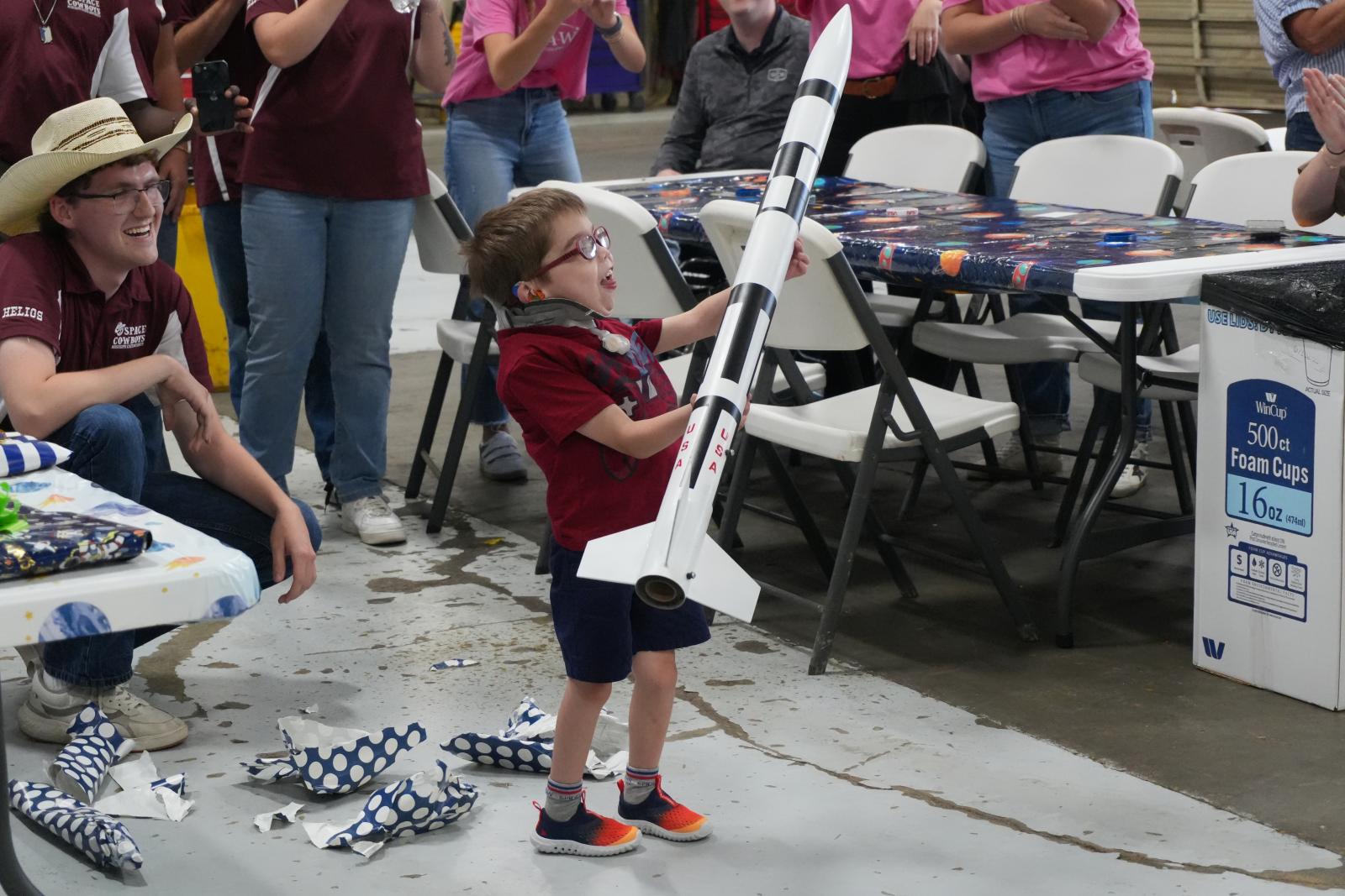 little boy holds a rocket