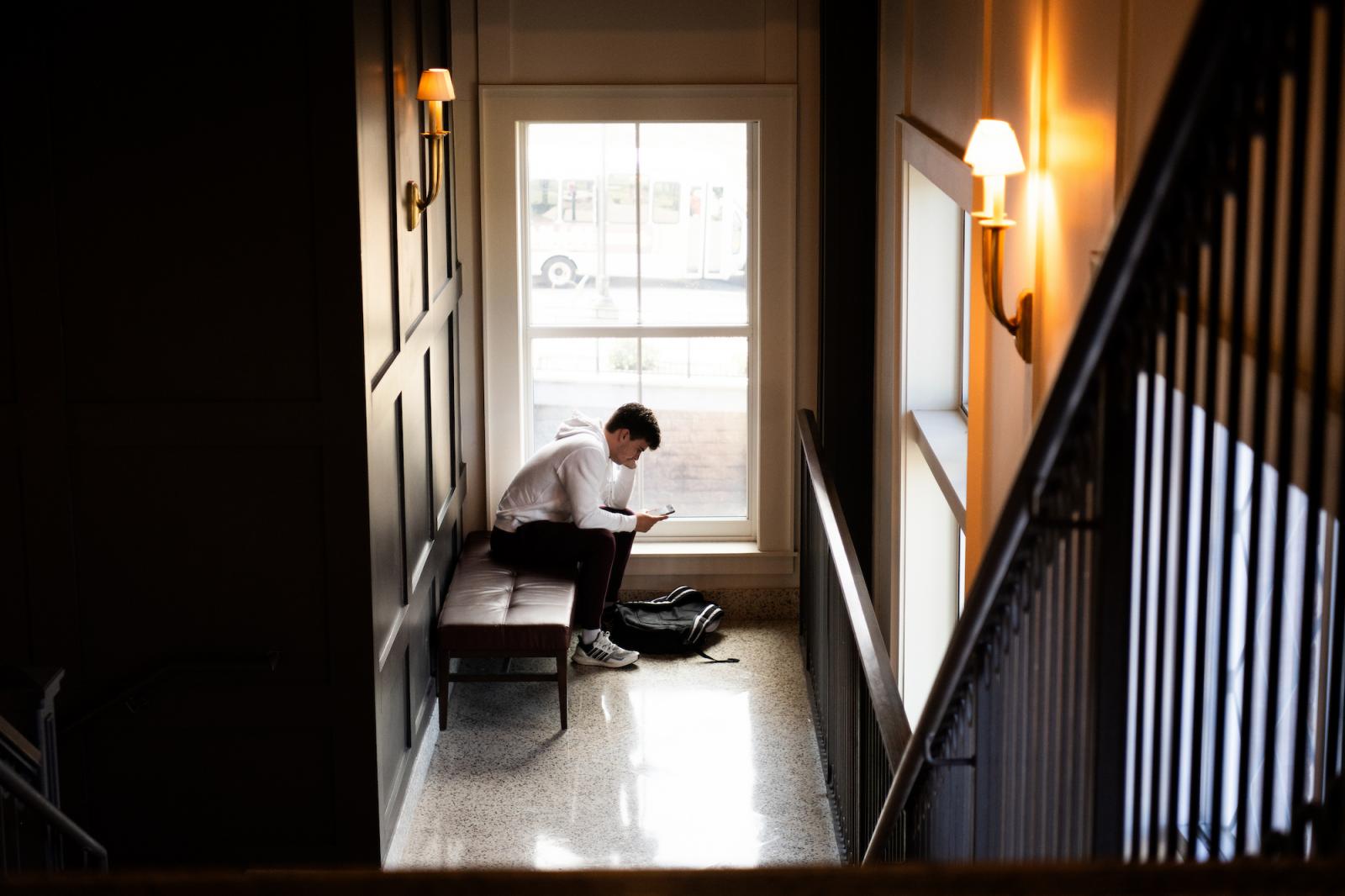 A student reads by a window in Old Main Academic Center