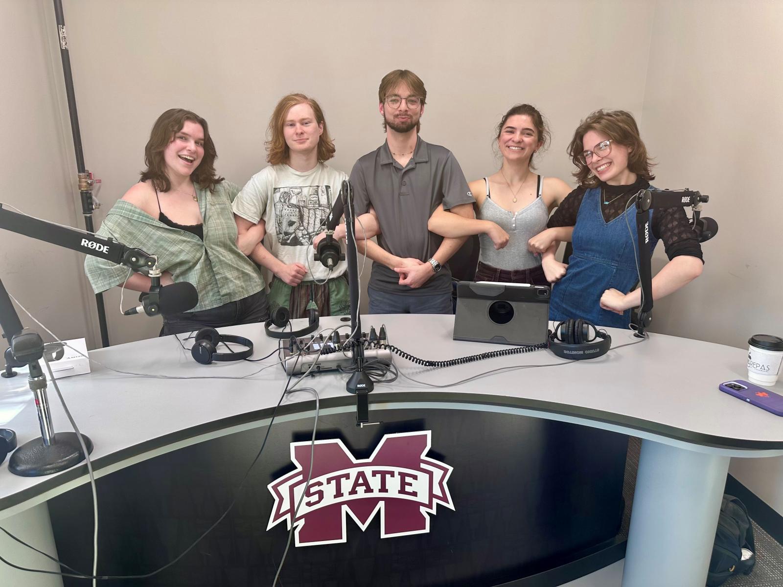 group of students behind ms state desk