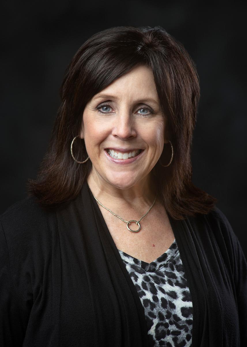 woman in black sweater on dark background