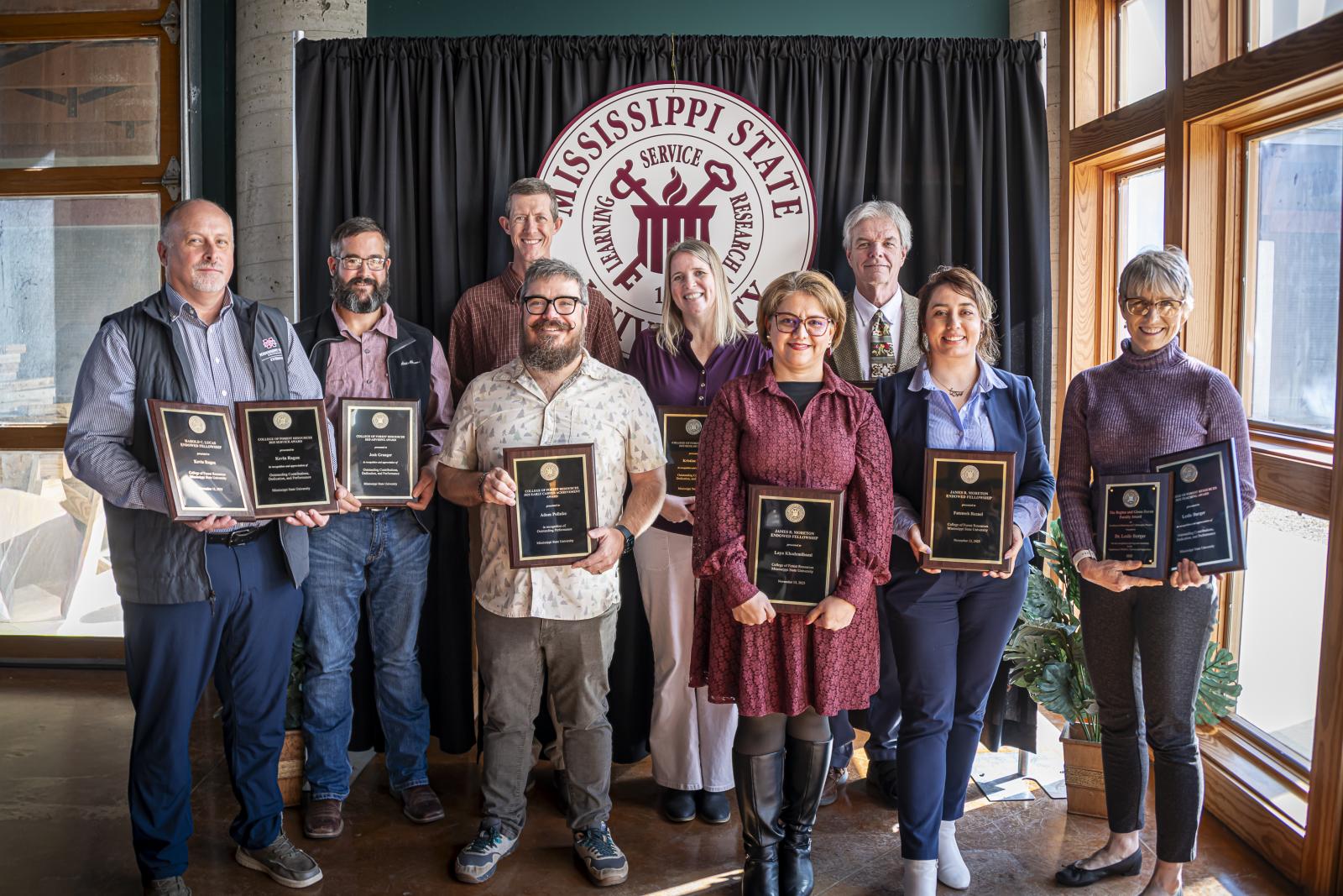 group of employees lined up with awards