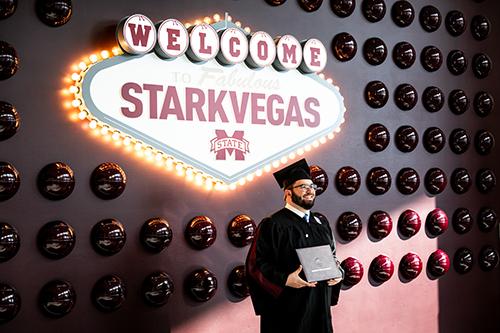 A Mississippi State 2025 fall graduate poses with his degree.