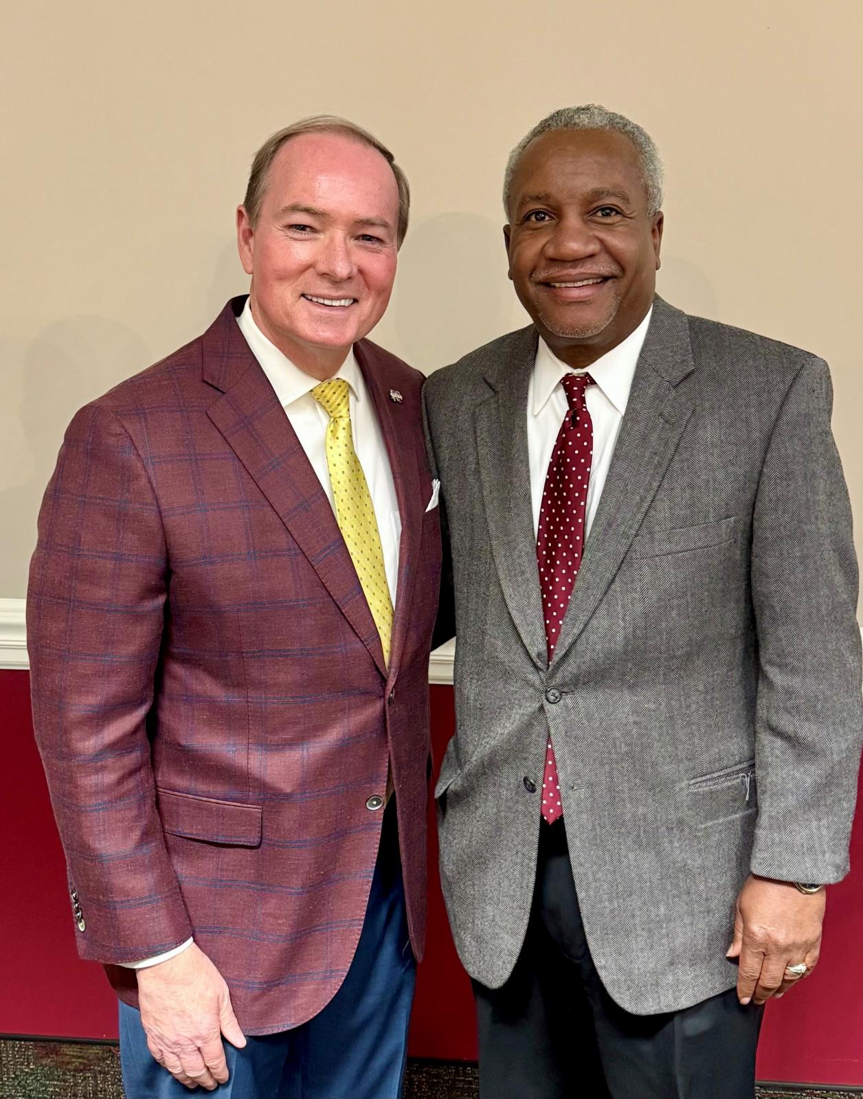 man in maroon jacket with man in grey jacket