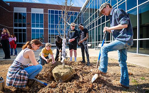 Students plant Arbor Day trees at Partnership Middle School.
