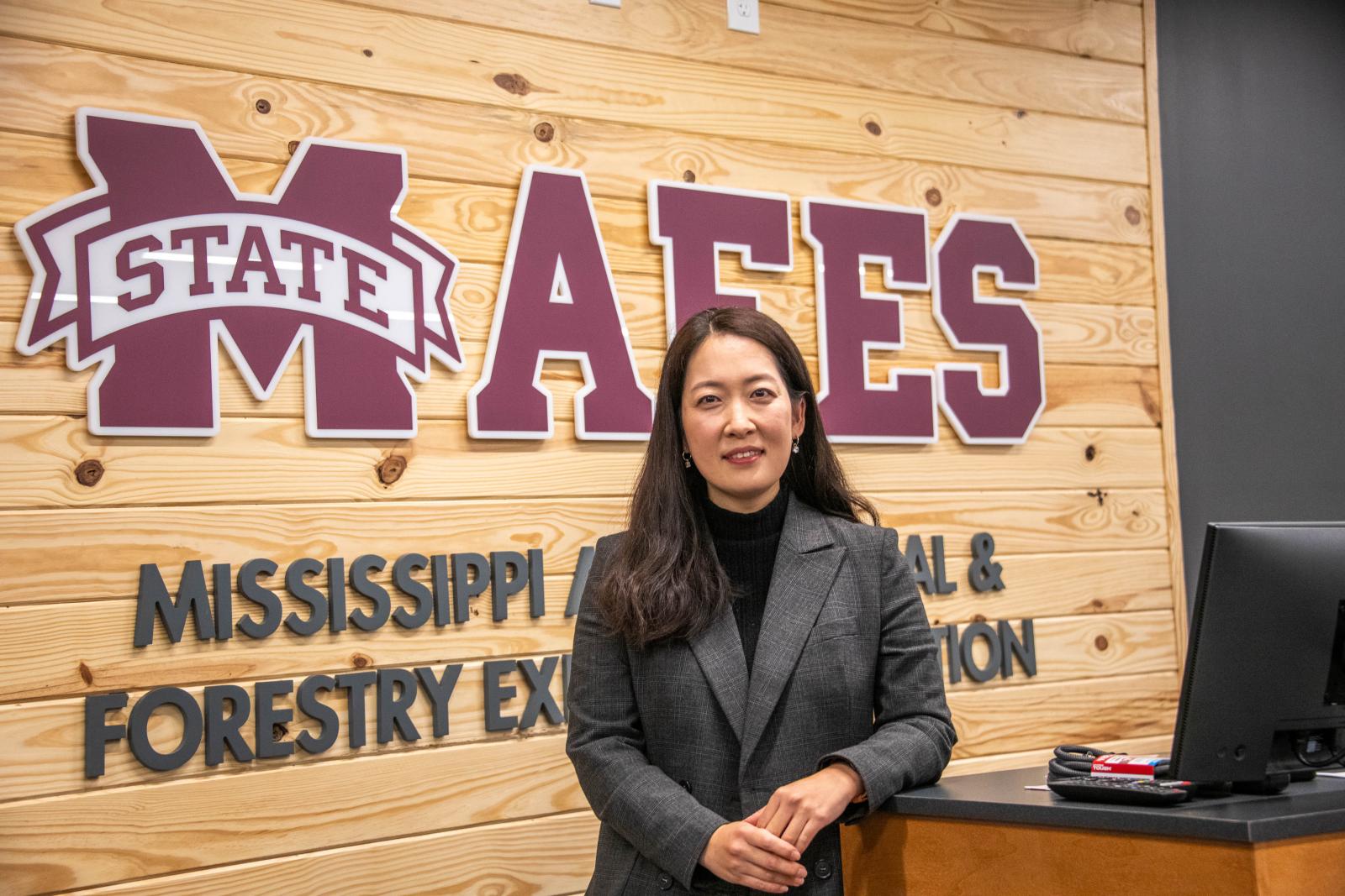 photo of new endowed professor in front of a mafes sign